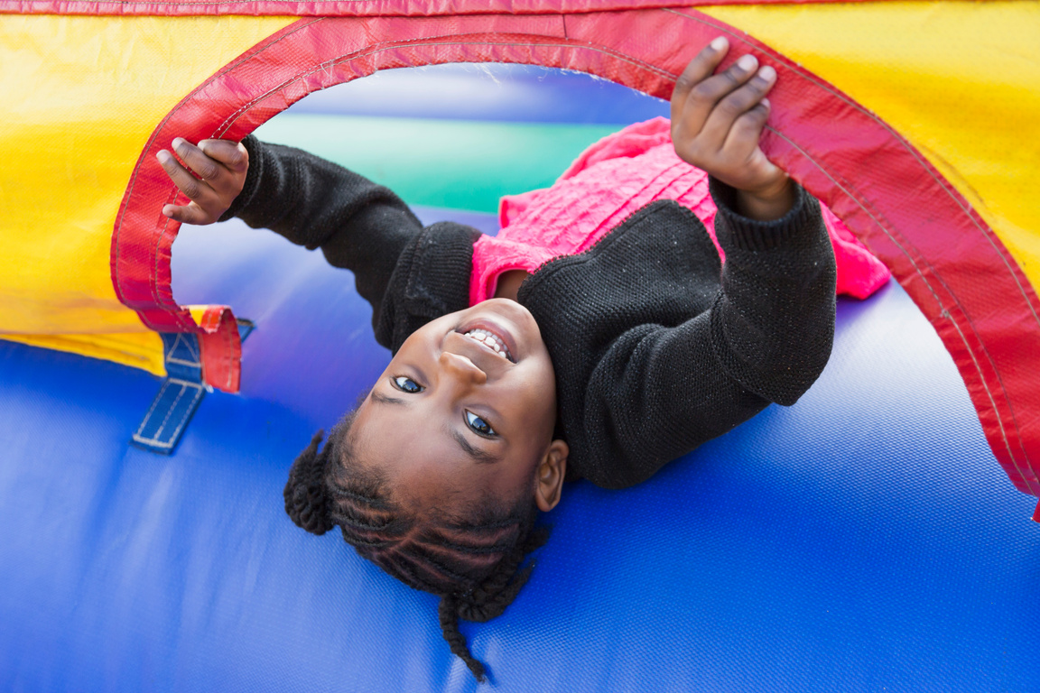 Little girl playing in bounce house