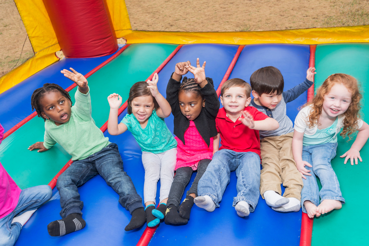 Multi-ethnic group of children in bounce house